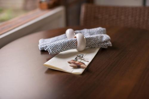 a table with a pair of scissors on a napkin at TorquayToongahra BnB in Torquay