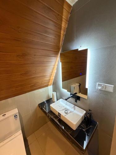 a bathroom with a sink and a mirror at Sinharaja Kithula Eco Cabanas in Batuwangala