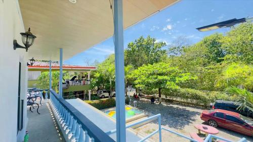 a view from the porch of a house with a pool at Hospedaje de la playa in Sámara