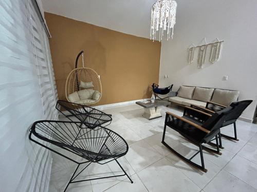 a living room with black chairs and a couch at Villa Del Mar 14 in Antón Lizardo