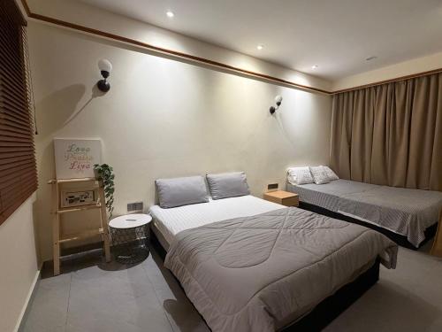 a hotel room with two beds and a window at Brassalova Signature Stay in Port Dickson