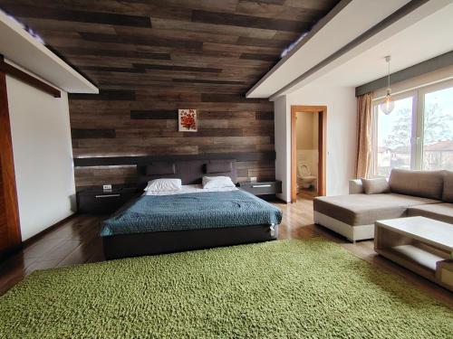 a bedroom with a bed and a couch at Villa Sarajevo Heights ex Villa Kolonija in Sarajevo