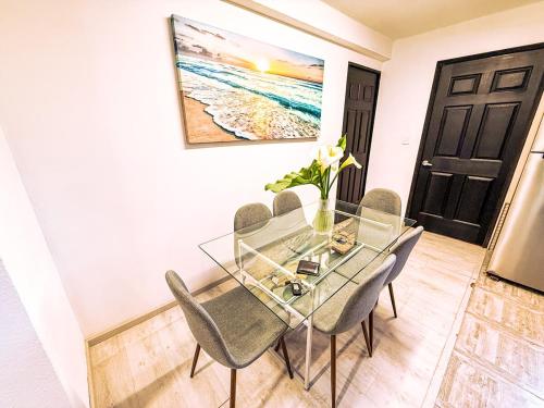 a dining room with a glass table and chairs at Departamento completo para 6 personas a 3 Min del Estadio Azteca-Banorte y muy cerca de la zona de Hospitales in Mexico City