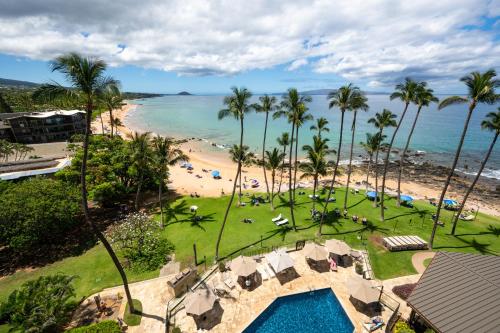 an aerial view of a beach with palm trees and a resort at Mana Kai Maui Condo - Right on the Beach! in Wailea