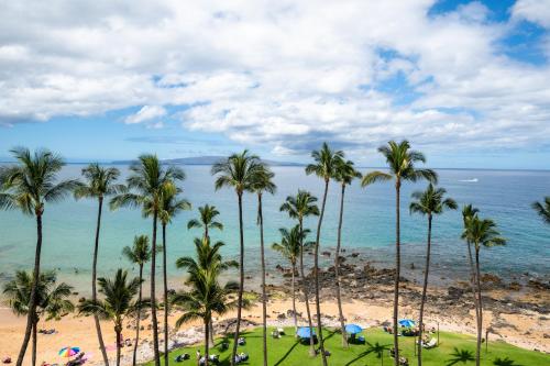 a view of a beach with palm trees and the ocean at Mana Kai Maui Condo - Right on the Beach! in Wailea
