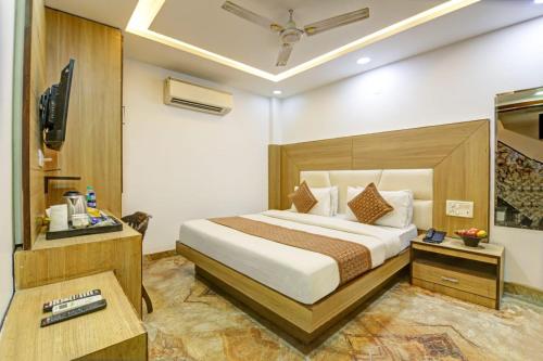 a hotel room with a bed and a television at Hotel IVY Near Delhi Airport in New Delhi