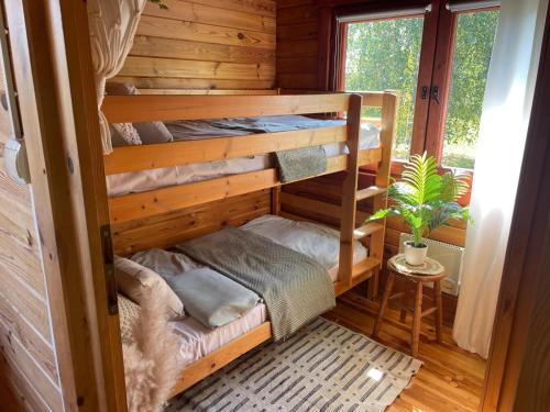 a bedroom with bunk beds in a log cabin at Domki Letniskowe Kalem in Zabin