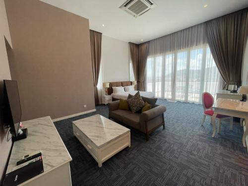 a living room with a couch and a table in a room at Casa Bianca in Kluang
