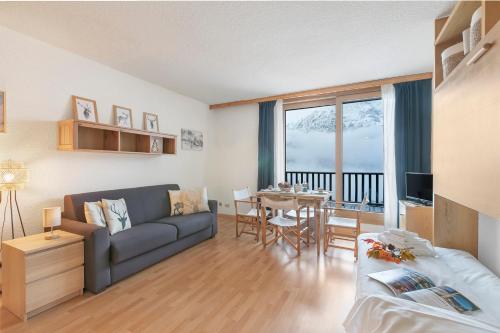 a living room with a couch and a table at Studio Sansi 34 - Happy Rentals in Cesana Torinese