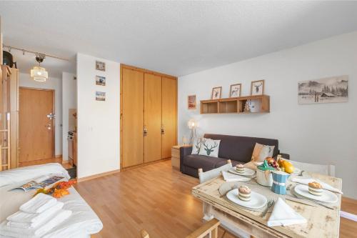 a living room with a couch and a table at Studio Sansi 34 - Happy Rentals in Cesana Torinese