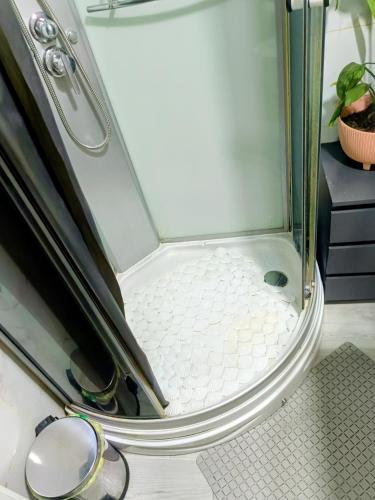 a shower with a glass door next to a shower at Jupiter in Split