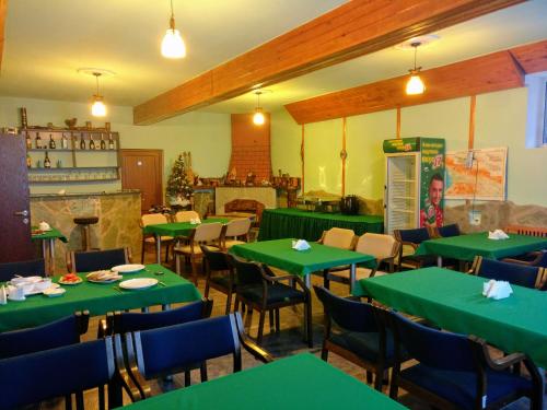 a dining room with green tables and chairs at Gagieti in Gudauri