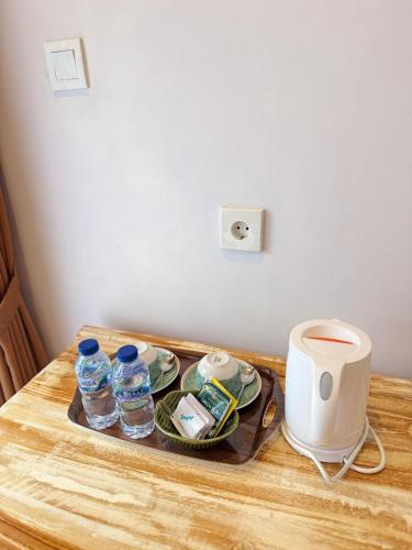 a tray with water bottles on top of a table at Willy Homestay in Uluwatu