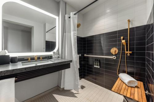 a bathroom with a sink and a mirror at Hyatt Centric Chicago Ohare in Rosemont