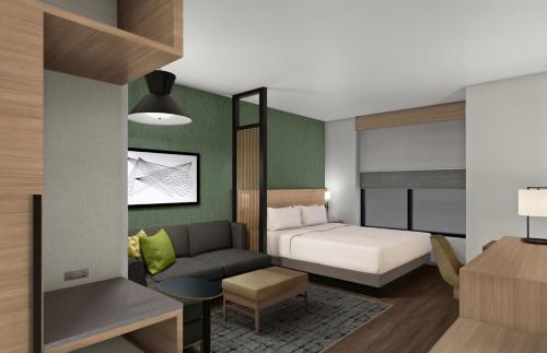 a hotel room with a bed and a couch at Hyatt Place Guyana Georgetown in Georgetown