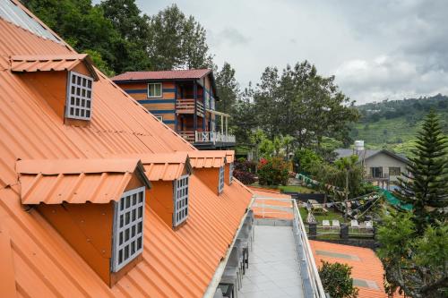 an overhead view of a building with an orange roof at The Door to Nirvana Backpackers Hostel Kotagiri in Kotagiri