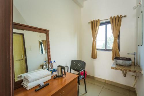 a room with a desk with a mirror and a chair at Vasant Vihar Resort in Kevadia