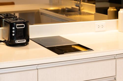 a camera sitting on top of a counter with a tablet at Cassia Apartment 1 in Bang Tao Beach
