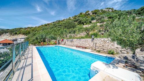 a swimming pool with a mountain in the background at Villa Matej by Villas Guide in Zaton