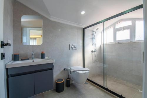 a bathroom with a shower and a toilet and a sink at Sureyya Hotel By Kalipso in Oludeniz