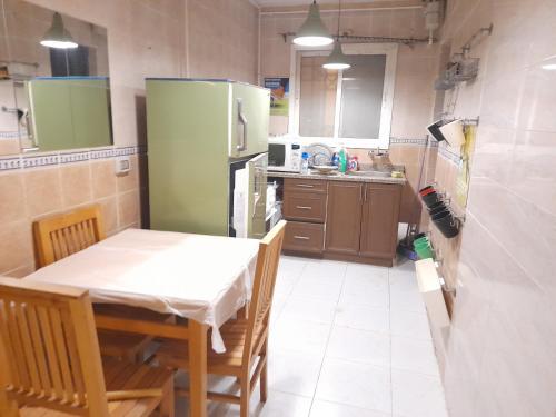 a small kitchen with a table and a table and chairs at Madinaty Summer cottage in Cairo