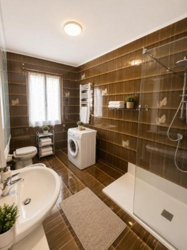 a bathroom with a sink and a toilet and a shower at APPARTAMENTI LA CONCHIGLIA in Caorle