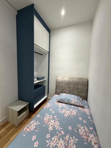 a bedroom with a bed and a blue cabinet at Sufi Idaman Homestay for Islamic only in Nilai