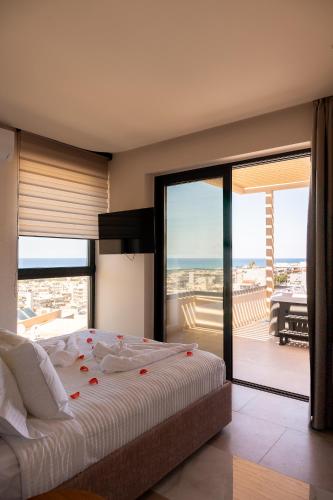 a bedroom with a bed with red flowers on it at Dea Rethymno in Rethymno