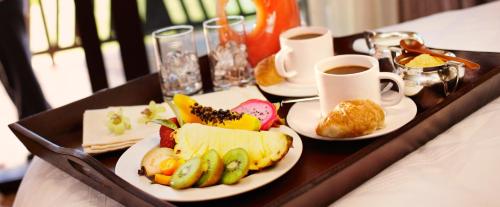 a tray with two plates of food and a cup of coffee at Hotel Square in Skopje