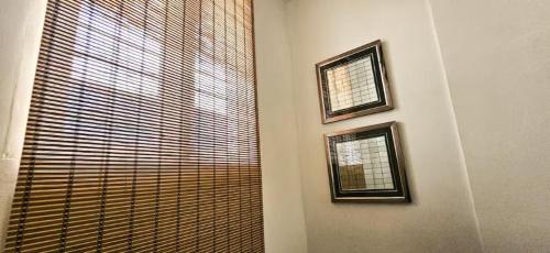 a room with two pictures on the wall next to a window at The Blessing Villa Vellore in Vellore