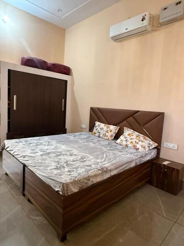 a bedroom with a large bed with two pillows on it at The Loft Homestay Narwana in Narwāna