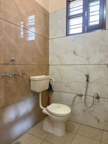 a bathroom with a toilet and a shower at The Loft Homestay Narwana in Narwāna