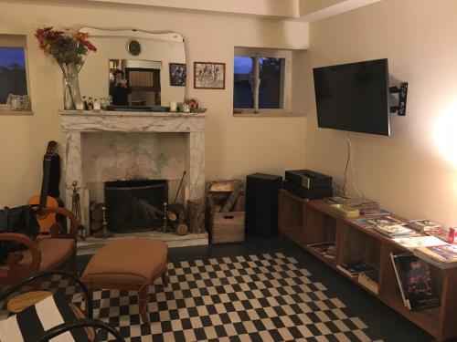 a living room with a fireplace and a television at BellaVista Bike Stop in Spoltore