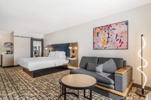 a hotel room with a bed and a couch at Hampton Inn Atlanta-Stockbridge in Stockbridge