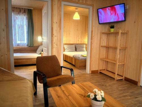 a small room with a bed and a couch and a table at Elmona Villas in Kamchia