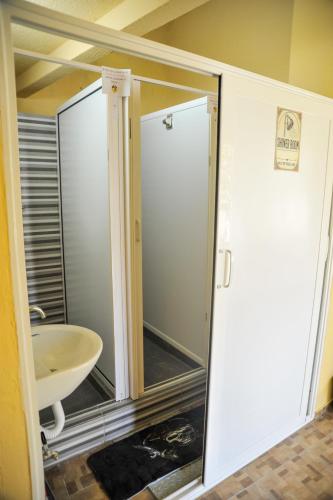 a bathroom with a shower and a sink at Pirate Backpackers in Ulcinj