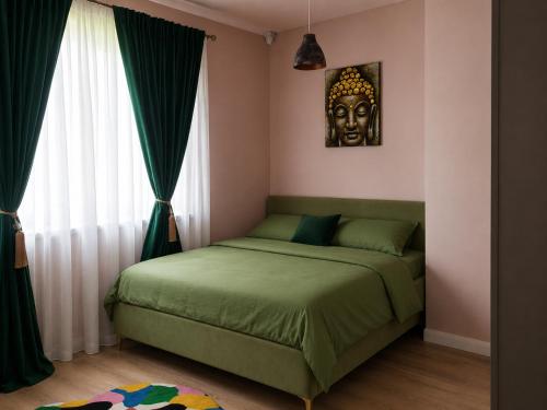 a bedroom with a bed with a mask on the wall at Garden of Silance in Cîrcea