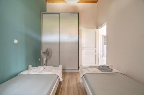 two beds in a room with a mirror at Traditional House in Rífion