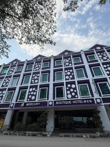 a building with a sign on the front of it at Mercury Boutique Hotel in Malacca