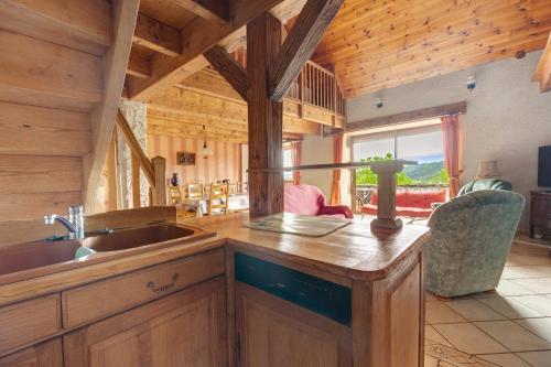 a kitchen with a sink and a counter in a cabin at Gîte Le Panorama in Rentières