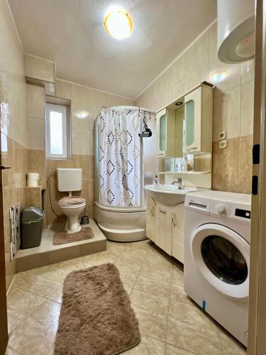 a bathroom with a washing machine and a toilet at PARIS Luxury Center Apartment STRUGA in Struga