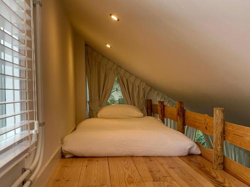 a bed in a room with a window at La Bastide in Heiloo