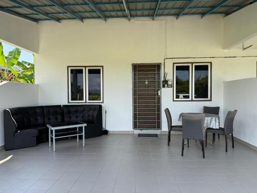 a living room with a couch and a table at Lot 766, Langkawi in Pulau Langkawi