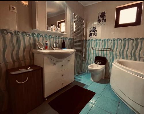 ein Badezimmer mit Waschbecken, Badewanne und Toilette in der Unterkunft O Casǎ in 23 August