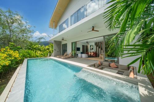 a swimming pool in the backyard of a house at Himmapana Villas - Hills in Kamala Beach