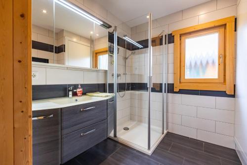 a bathroom with a shower and a sink at Bungalows am Senftenberger See in Großkoschen