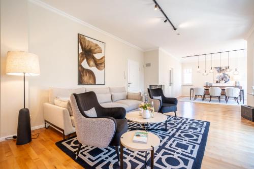 a living room with a couch and chairs and a table at Villa Lebensart - App 7 Lebensart in Ahlbeck