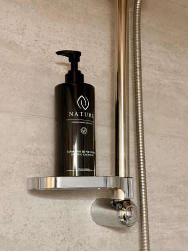 a soap dispenser in a bathroom with a shower at Domek z jacuzzi Wypoczynek Pod Lipami in Wólka