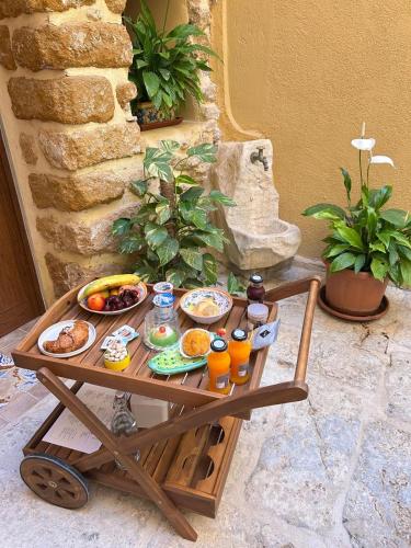 a tray of food on a wooden cart with food on it at BeB Omare Agrigento in Agrigento