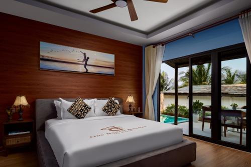 a bedroom with a bed with a view of the ocean at One Beach Resort by EHM in Koh Rong Sanloem